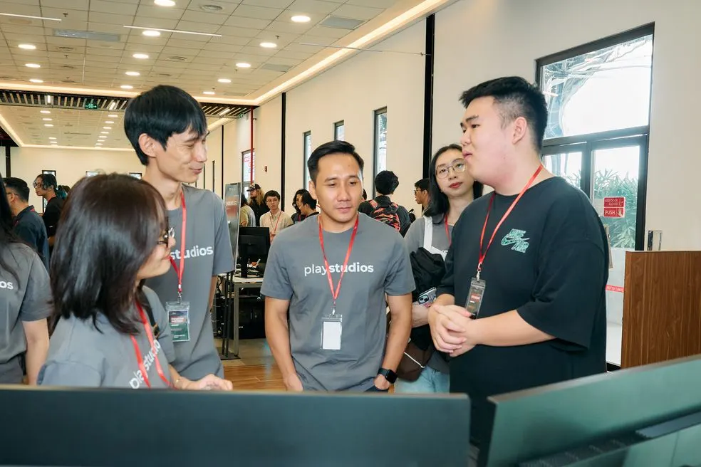 Nguyen Van Tuan and the PlayStudios team trying student projects