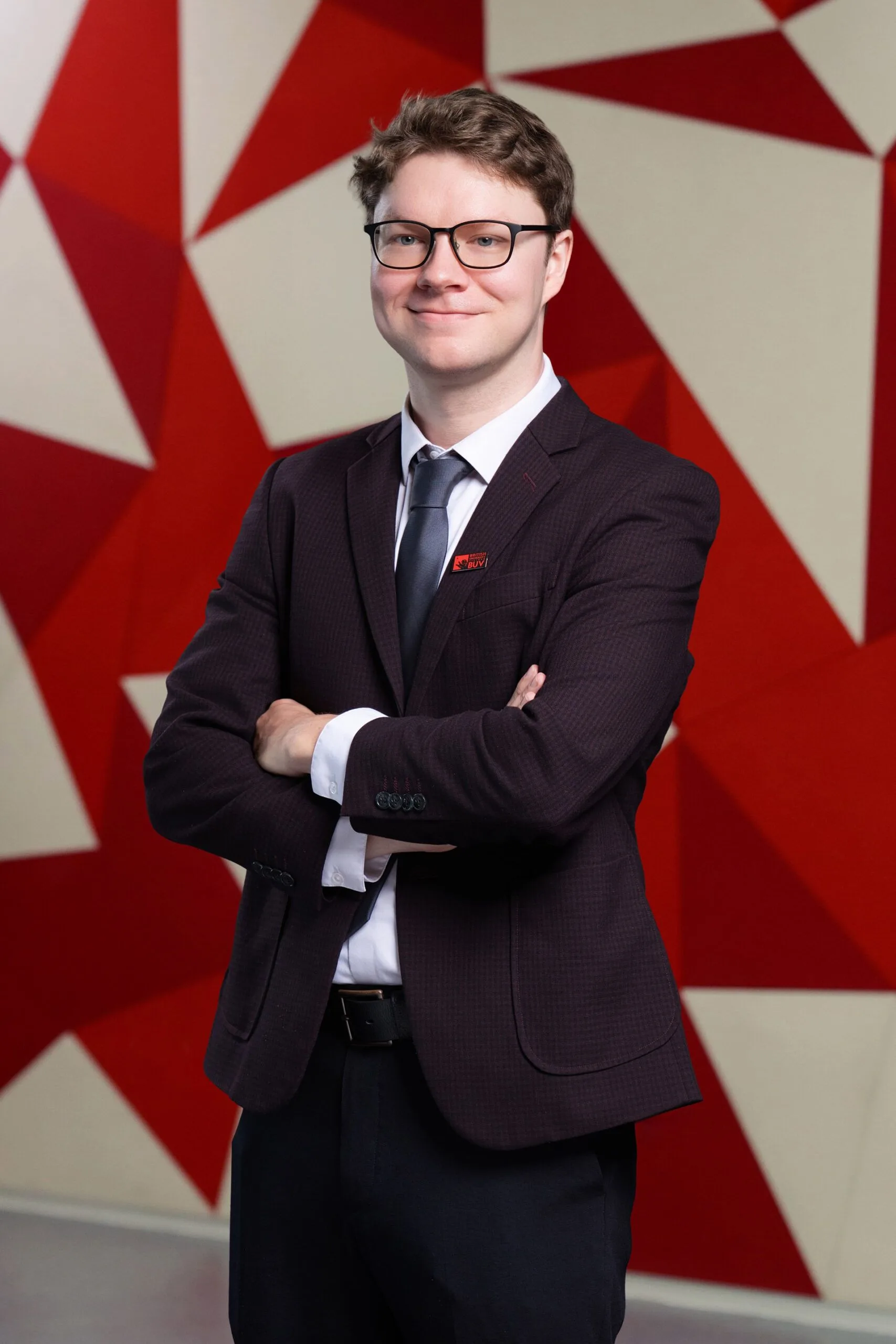 David Holloway wearing a suit and BUV badge at British University Vietnam