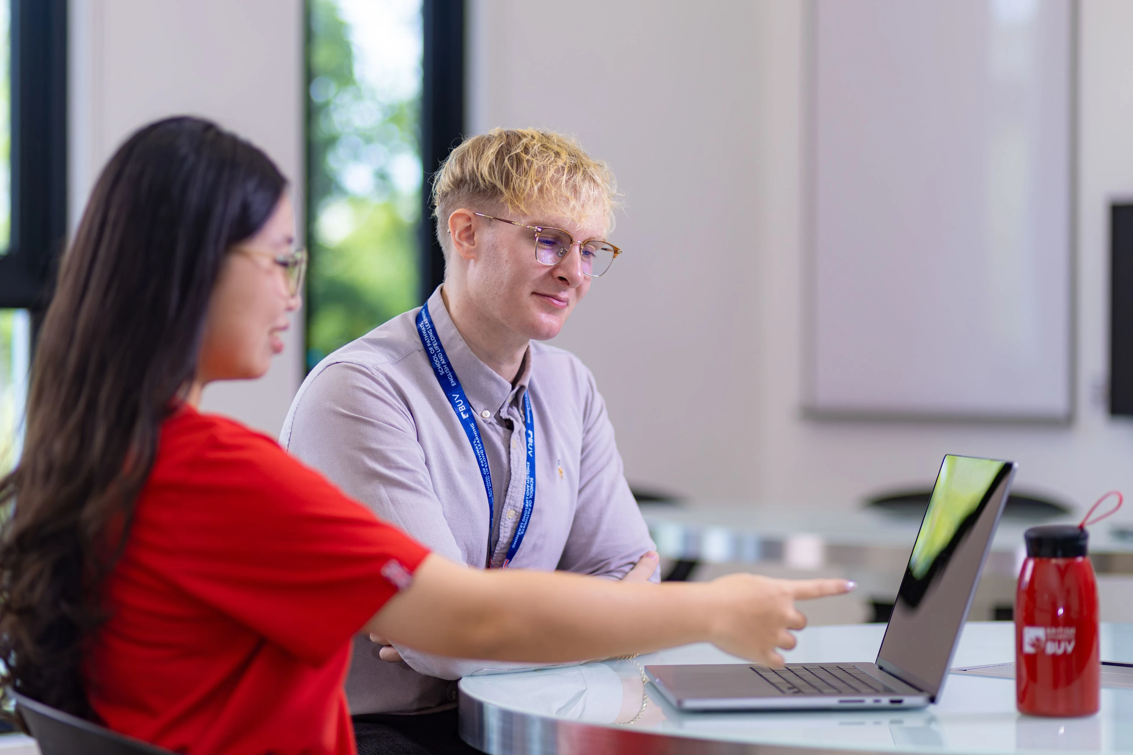 British University Vietnam students collaborating on a laptop in a modern classroom