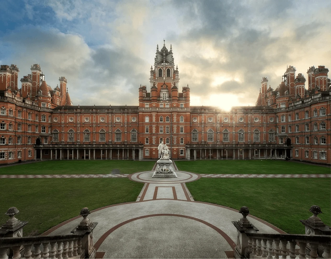 Royal Holloway, University of London campus courtyard with historic red-brick Founder’s Building